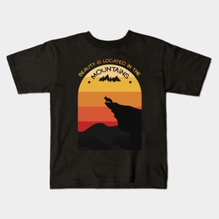 Beauty is located in the mountains Kids T-Shirt